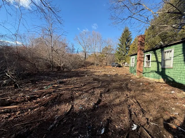 a backyard of a house with large trees
