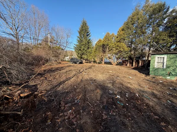 a backyard of a house with large trees