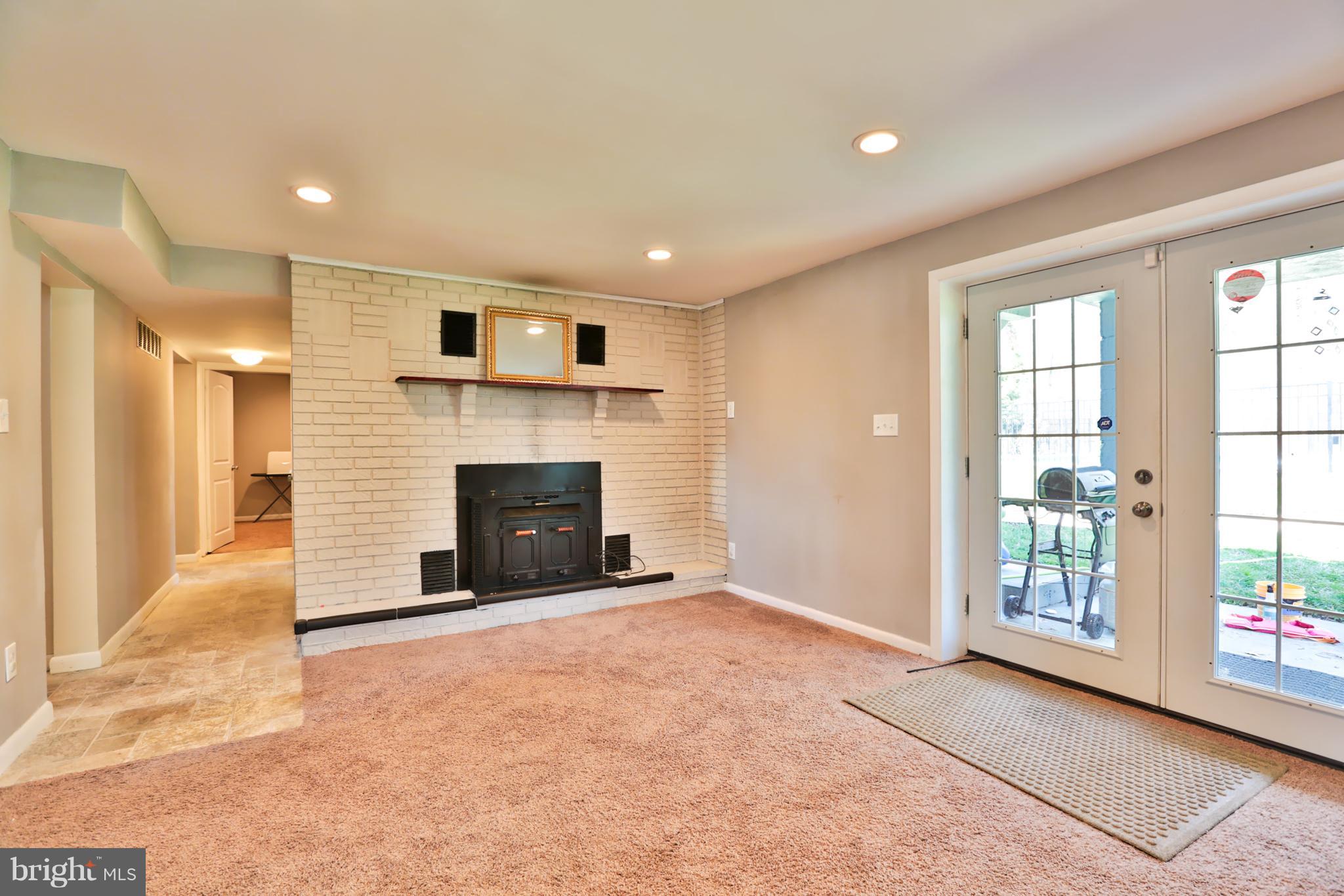 6022 Point Pleasant Road Baltimore, MD 21206 - Photo 15 of 23 fireplace and french doors in basement!