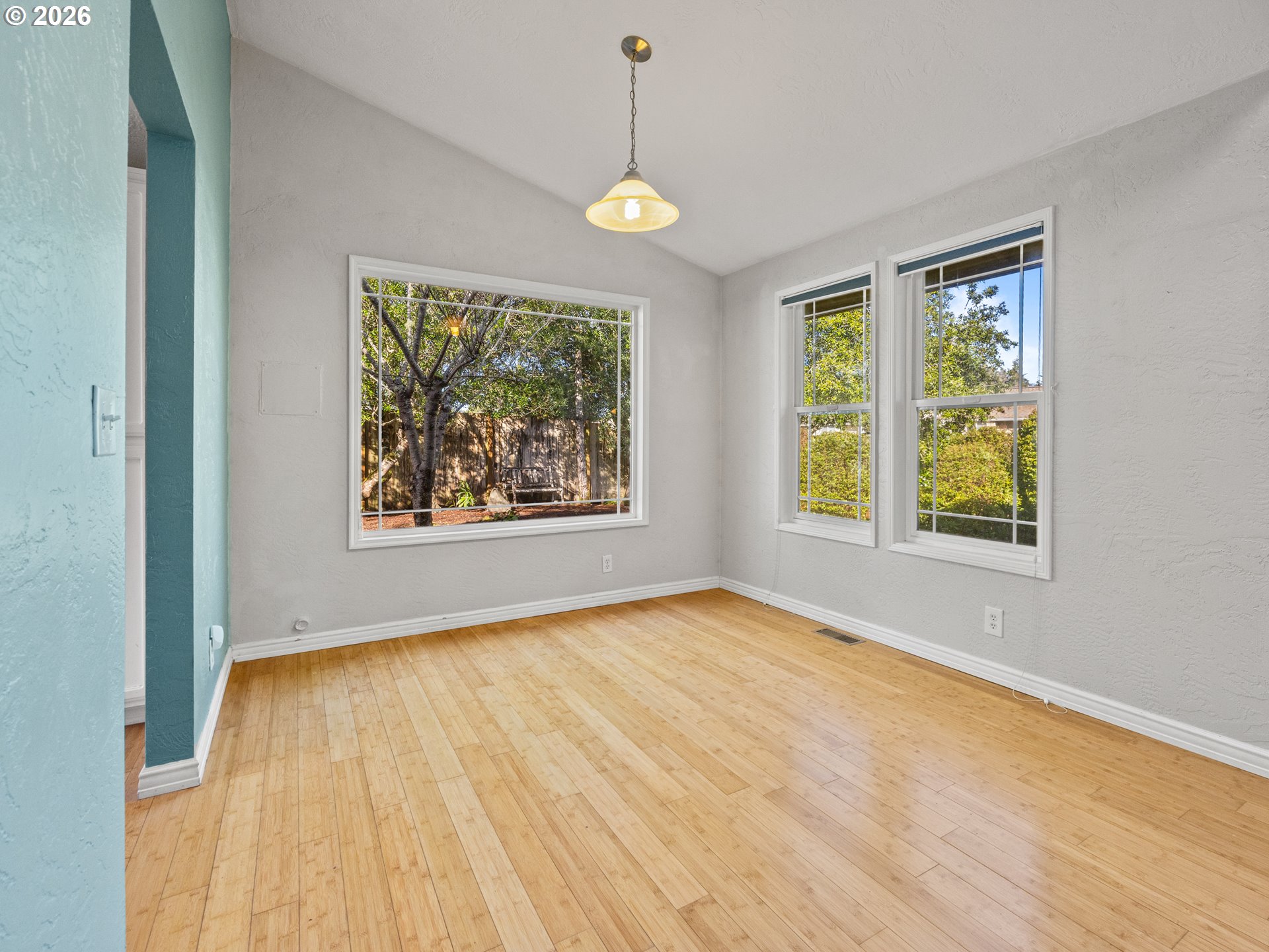 2066 40th Street Florence, OR 97439 - Photo 15 of 48 a view of an empty room with a window and wooden floor