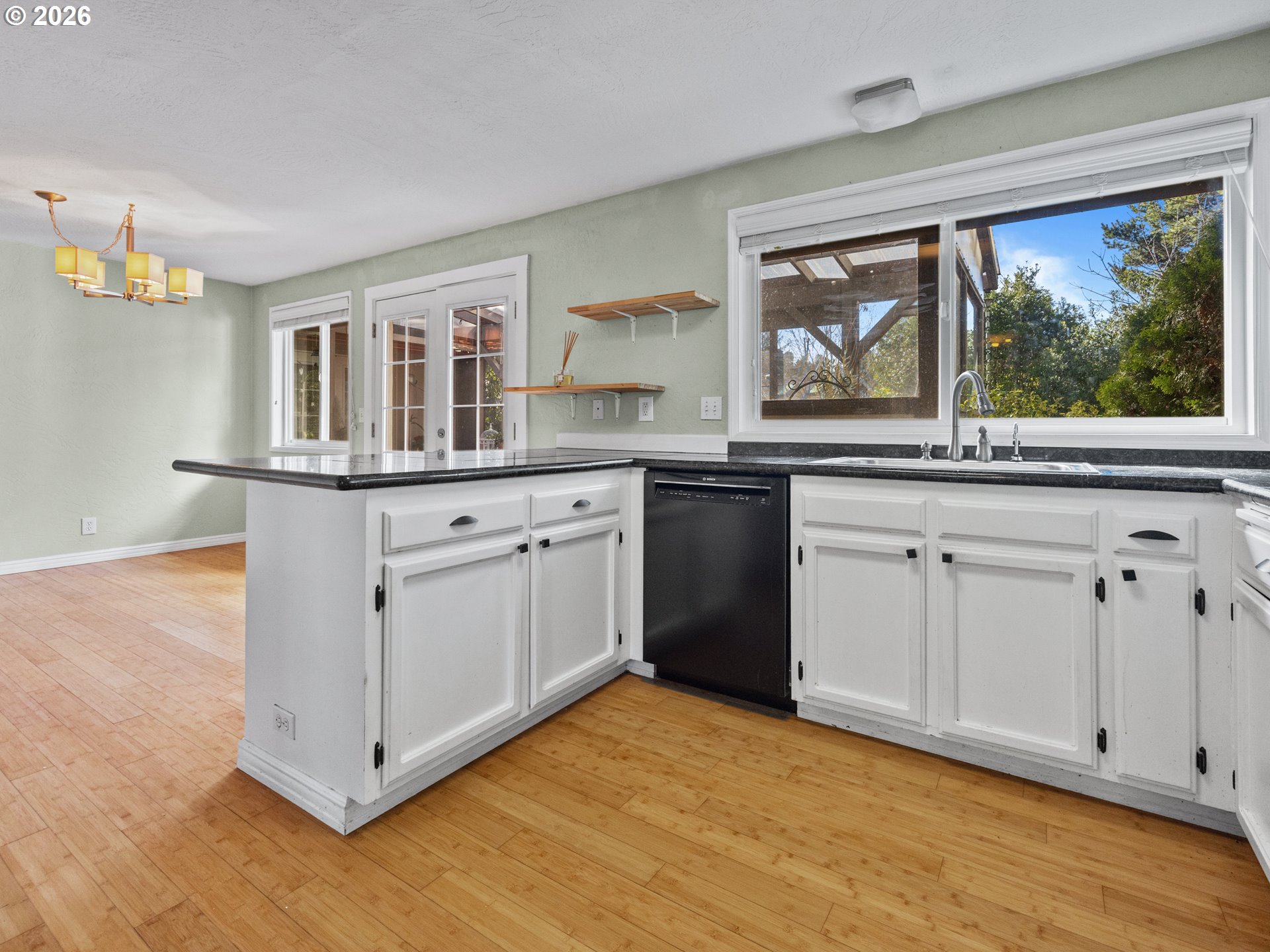 2066 40th Street Florence, OR 97439 - Photo 18 of 48 a kitchen with stainless steel appliances granite countertop a stove and cabinets
