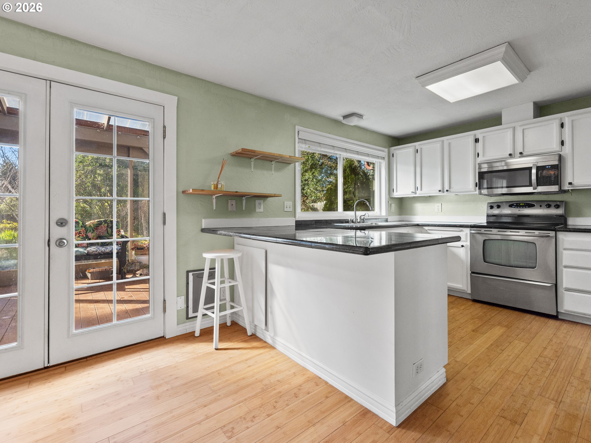 2066 40th Street Florence, OR 97439 - Photo 23 of 48 a kitchen with stainless steel appliances granite countertop a stove a sink and a microwave