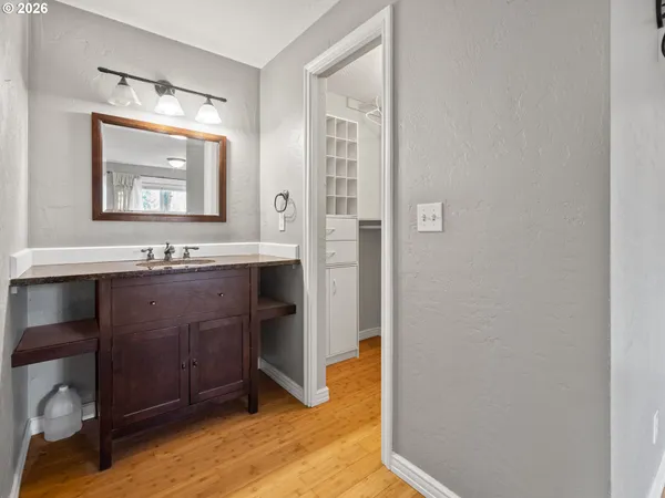 a bathroom with a sink a mirror and a shower