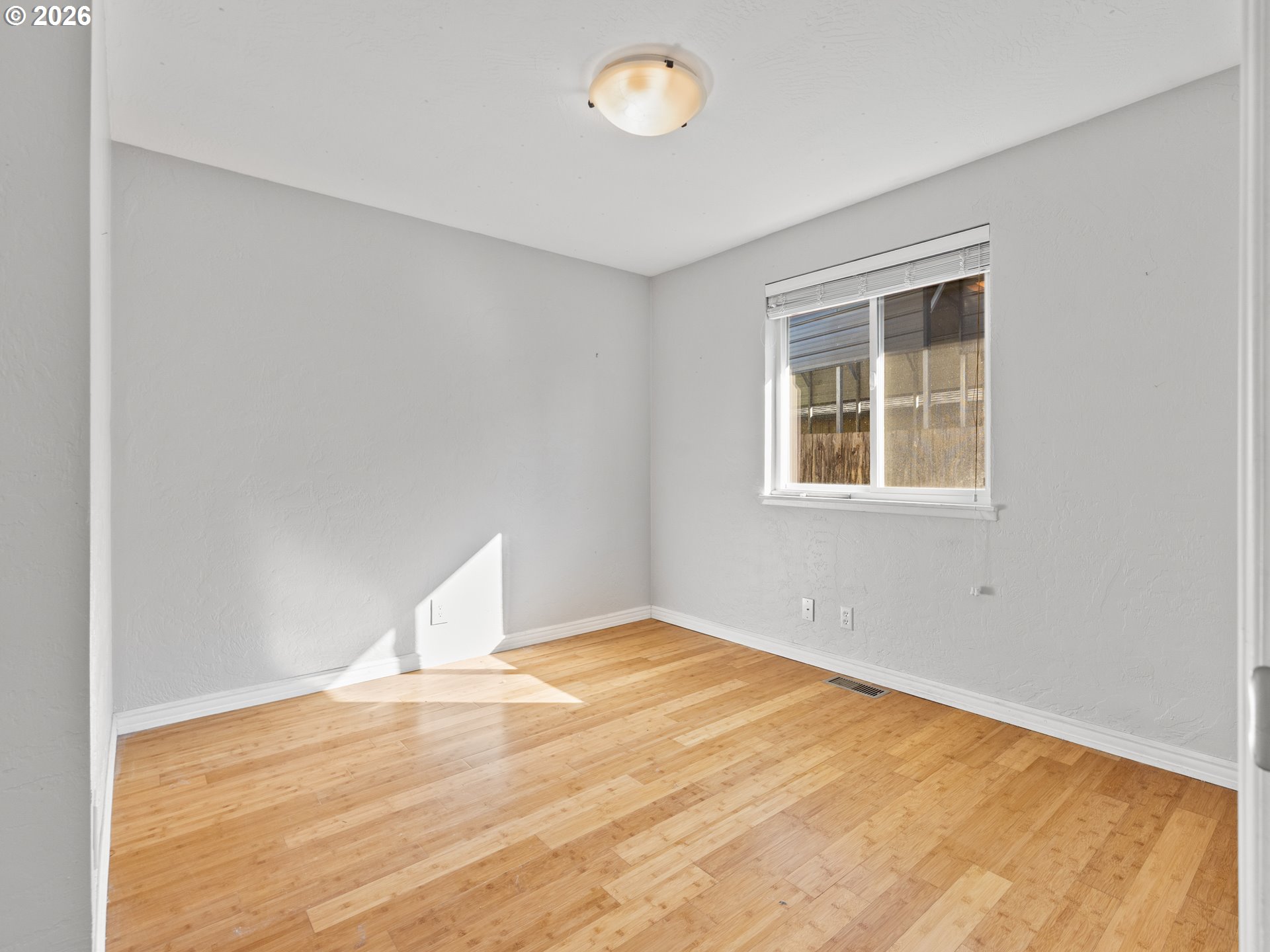 2066 40th Street Florence, OR 97439 - Photo 37 of 48 a view of empty room with wooden floor and fan