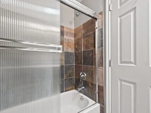 a bathroom with a shower and a sink