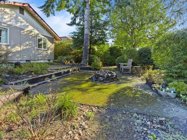 a view of swimming pool with lawn chairs and plants