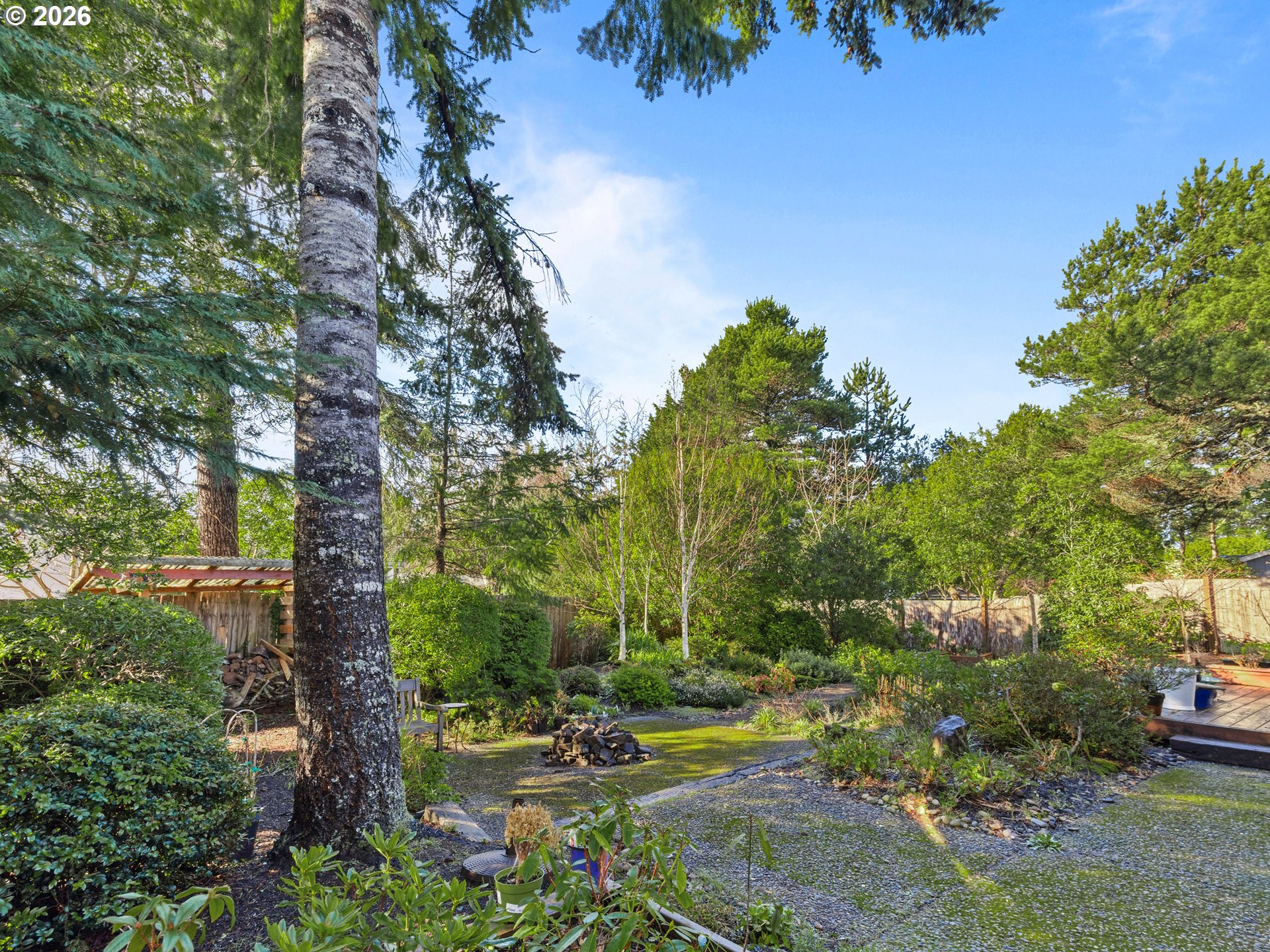 2066 40th Street Florence, OR 97439 - Photo 47 of 48 a backyard of a house with lots of green space
