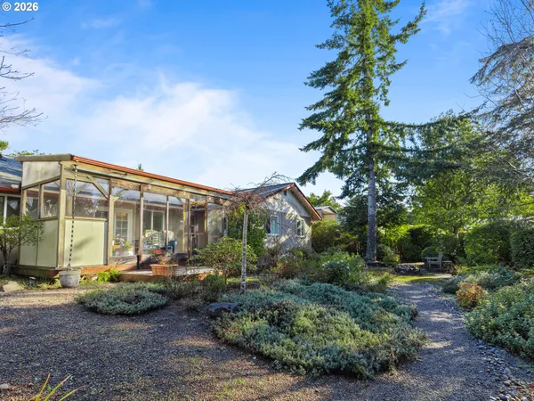 a view of a house with backyard and sitting area