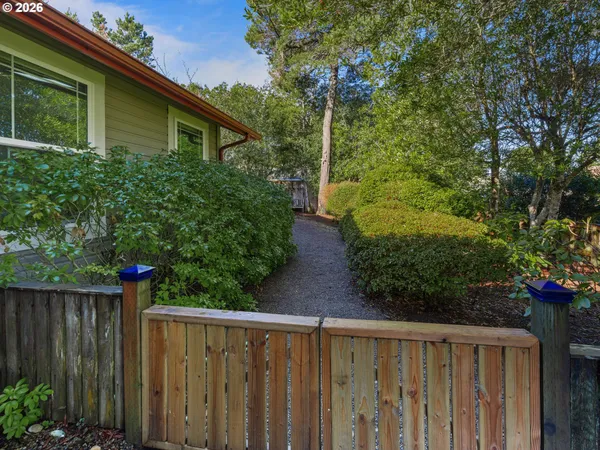 a view of a pathway of a house with wooden fence