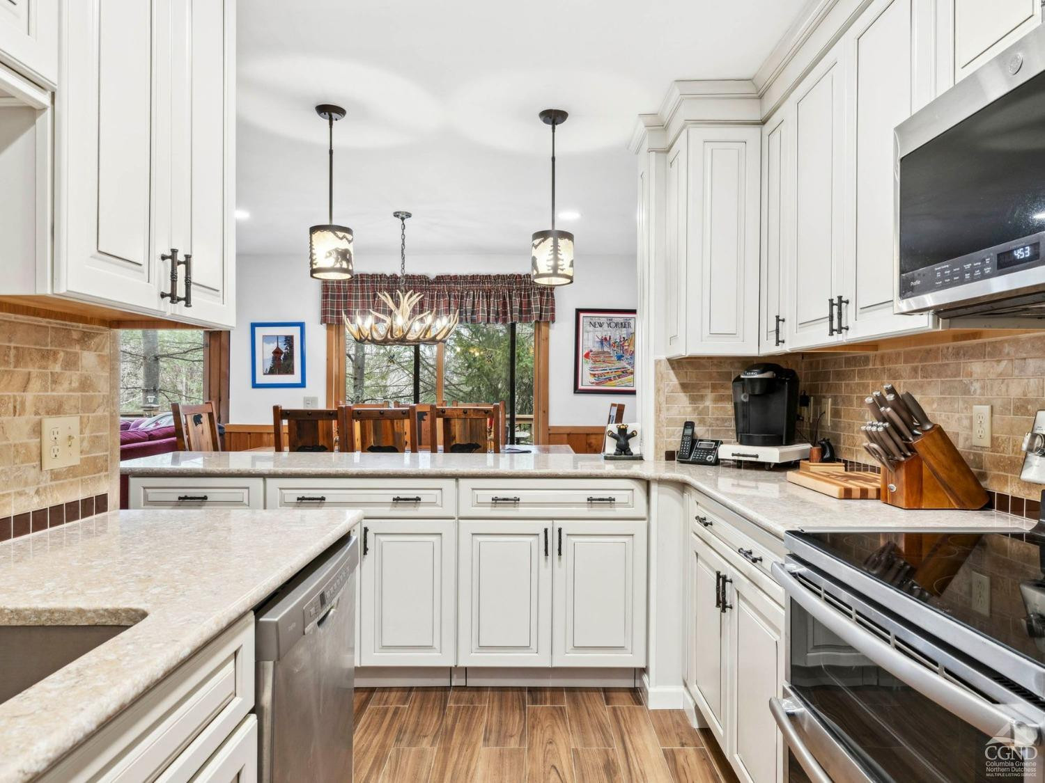57 Brainard Ridge Road, Unit 3E Windham, NY 12496 - Photo 17 of 55 a kitchen with a sink stove and cabinets