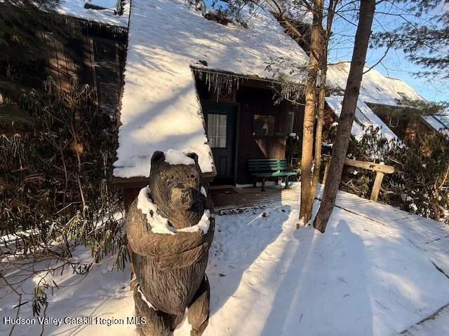 a living room with furniture a fireplace and floor to ceiling windows