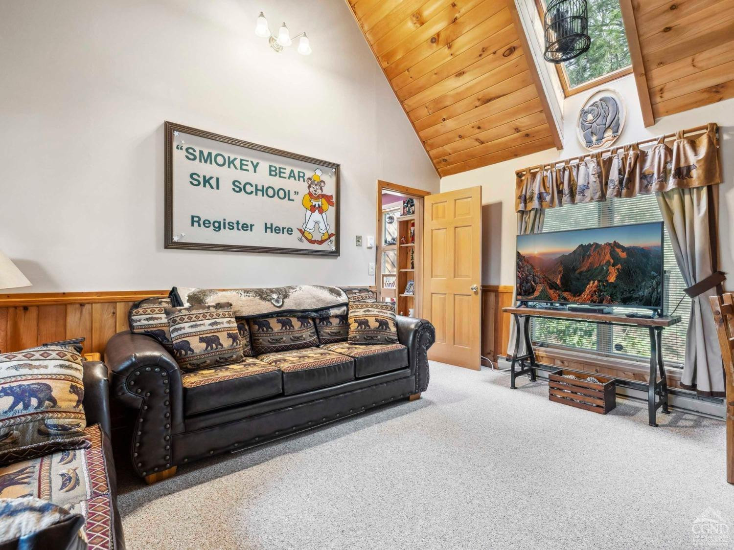 57 Brainard Ridge Road, Unit 3E Windham, NY 12496 - Photo 24 of 55 a living room with furniture and a flat screen tv