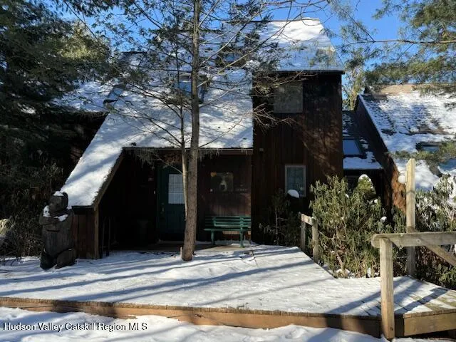 a kitchen with stainless steel appliances granite countertop a stove top oven a sink a dining table and chairs with wooden floor