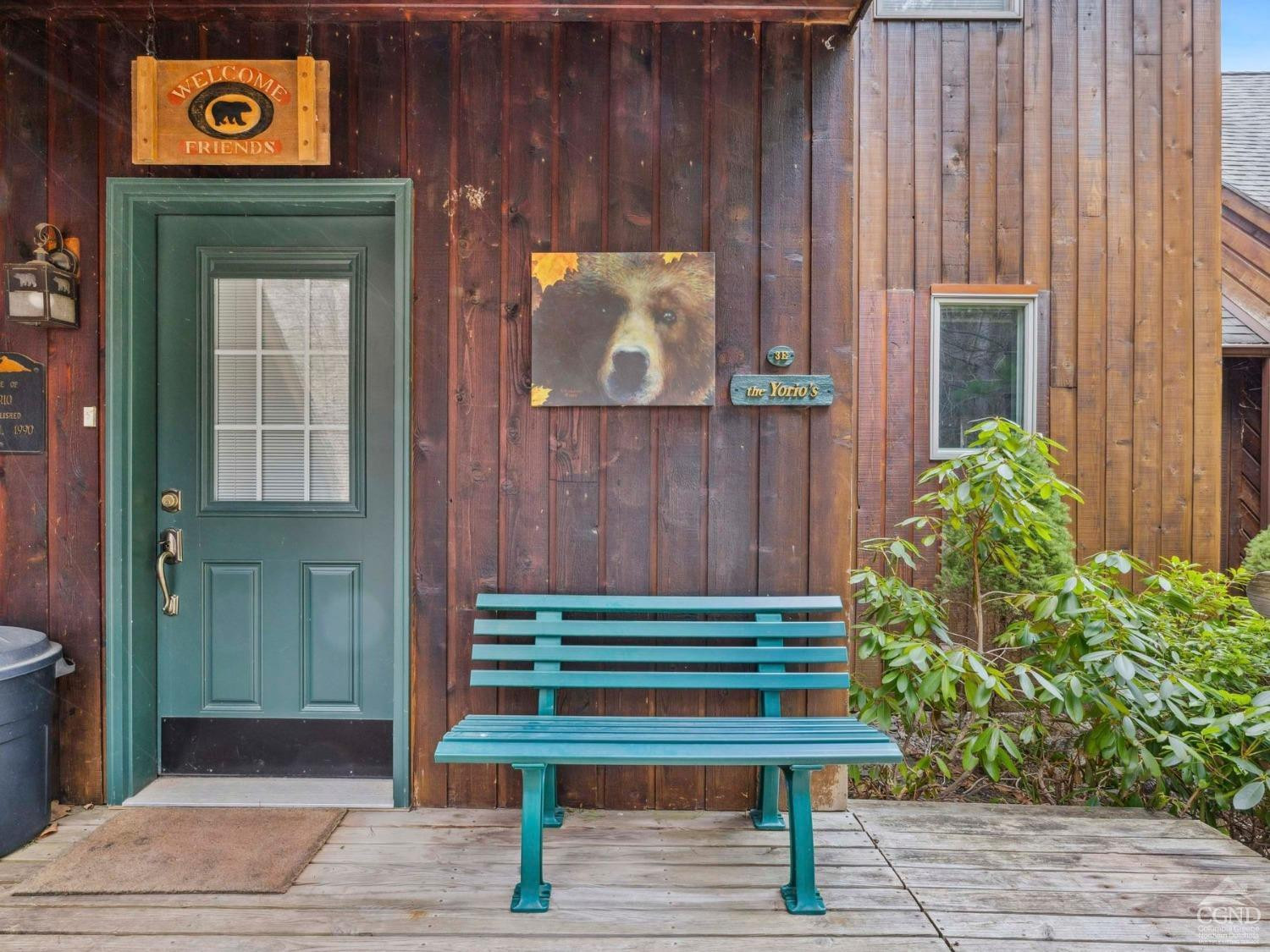 57 Brainard Ridge Road, Unit 3E Windham, NY 12496 - Photo 49 of 55 a small garden with a bench and potted plants
