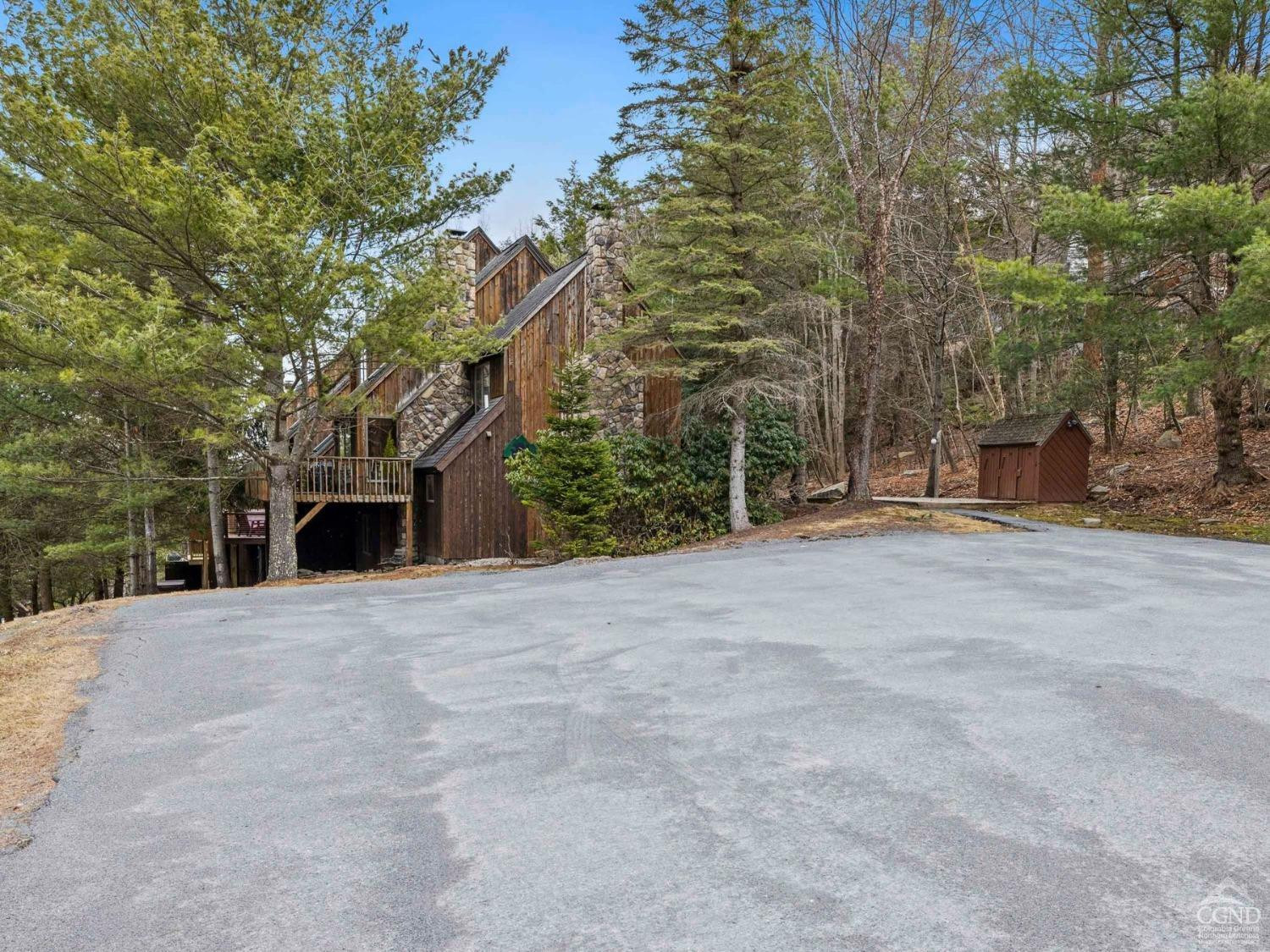57 Brainard Ridge Road, Unit 3E Windham, NY 12496 - Photo 52 of 55 a front view of a house with a yard and garage
