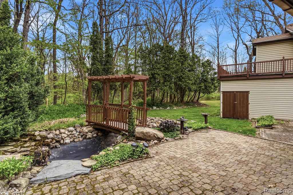 11111 Hibner Road Hartland, MI 48353 - Photo 44 of 59 View of patio featuring a garden pond and a wooden deck