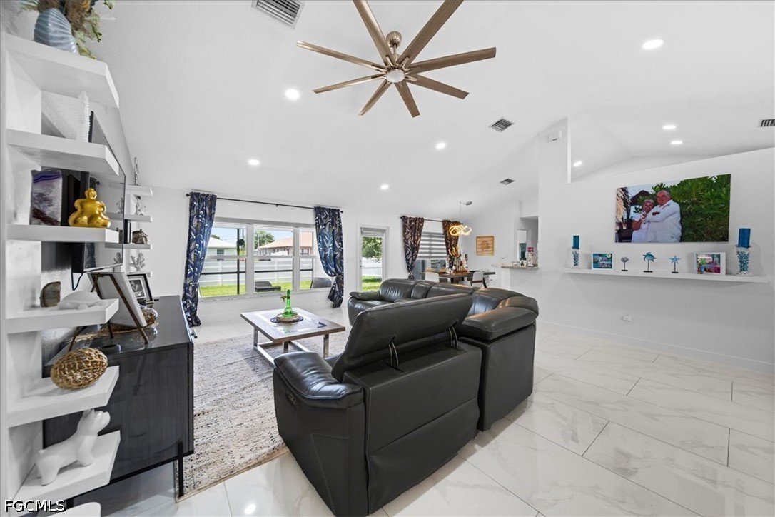 22 Nelson Road South Cape Coral, FL 33991 - Photo 24 of 43 a living room with furniture and a flat screen tv
