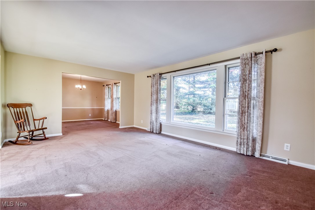 6145 Hemingway Road Cleveland, OH 44143 - Photo 21 of 50 Spare room with plenty of natural light, a chandelier, and carpet flooring
