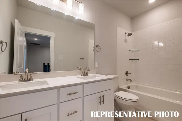 a spacious bathroom with a shower a sink and mirror
