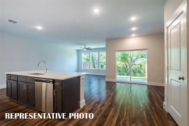 a kitchen with kitchen island white cabinets and stainless steel appliances