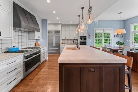 a large kitchen with stainless steel appliances a large counter top