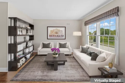 a living room with furniture and a book shelf
