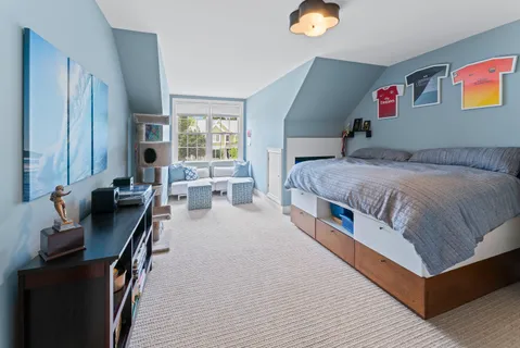 a spacious bedroom with a bed and a chandelier