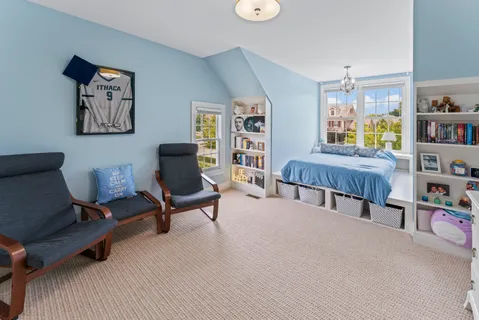 a living room with furniture and a book shelf