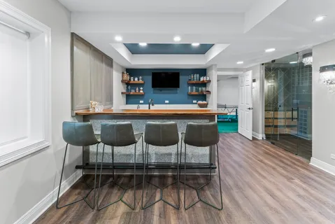 a kitchen with stainless steel appliances kitchen island granite countertop a table and chairs in it