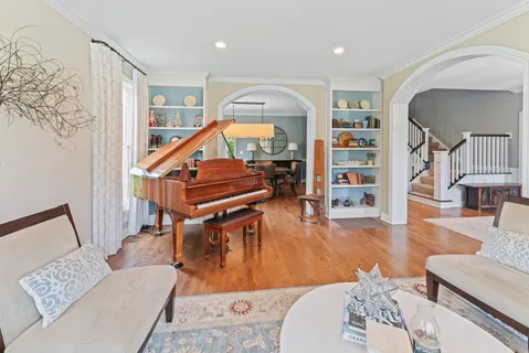 a living room with furniture and a wooden floor
