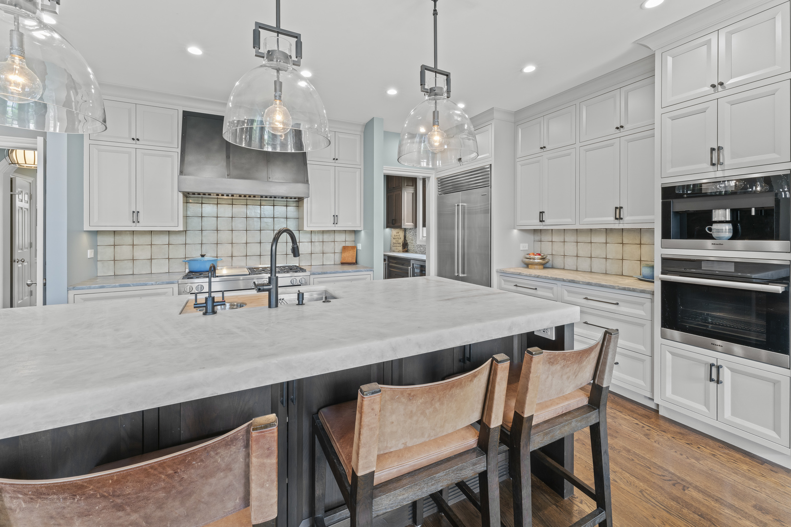 1546 Midway Lane Glenview, IL 60026 - Photo 9 of 46 a kitchen with stainless steel appliances a kitchen island hardwood floor sink stove and white cabinets