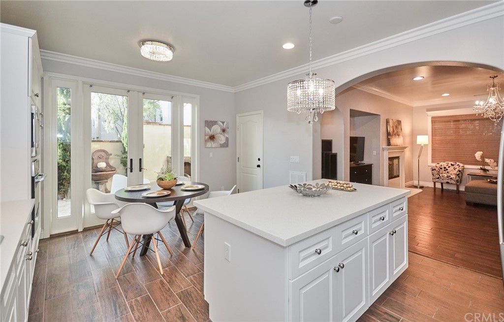 39 Conservancy Irvine, CA 92618 - Photo 11 of 32 a view of a kitchen counter top space with furniture and wooden floor