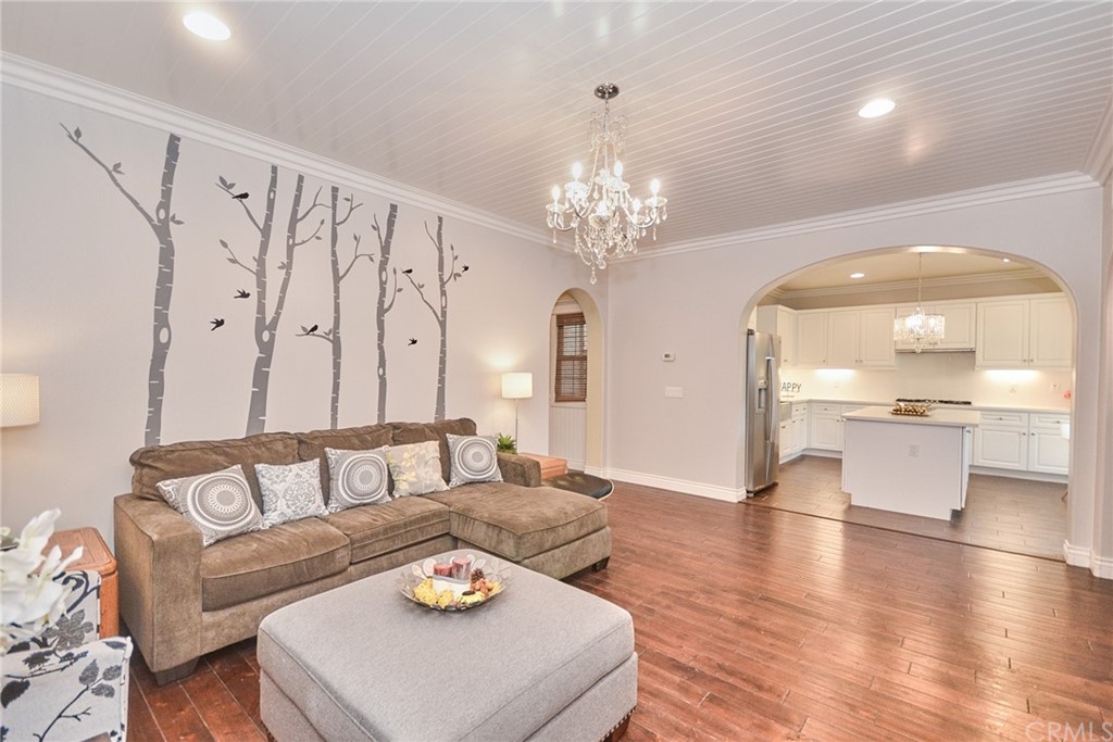 39 Conservancy Irvine, CA 92618 - Photo 12 of 32 a living room with furniture and a chandelier
