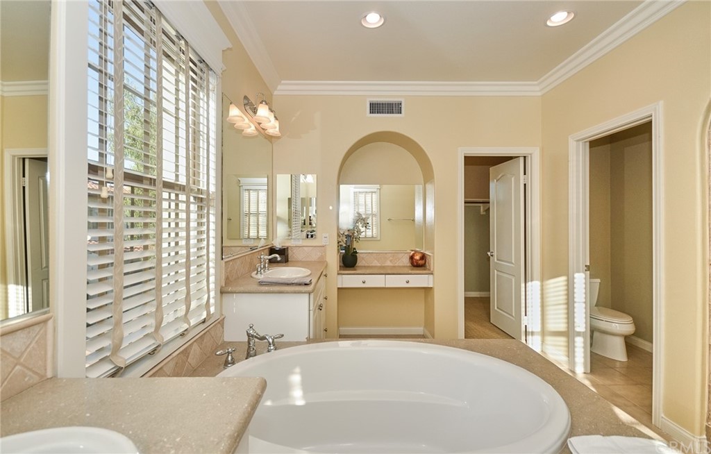 39 Conservancy Irvine, CA 92618 - Photo 16 of 32 a large white kitchen with a large window and stainless steel appliances