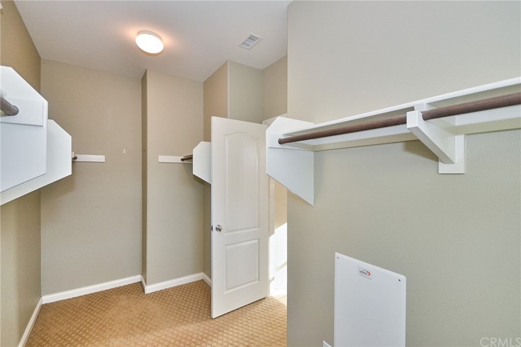 39 Conservancy Irvine, CA 92618 - Photo 21 of 32 a view of walk in closet with clothes and shoes