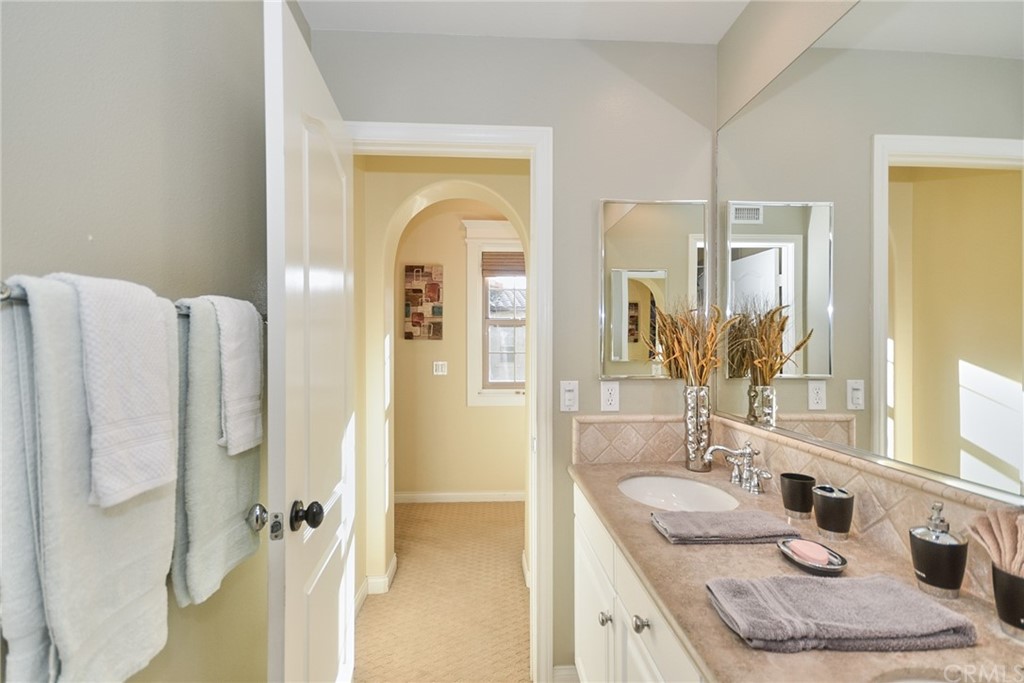 39 Conservancy Irvine, CA 92618 - Photo 24 of 32 a bathroom with a granite countertop sink and a mirror