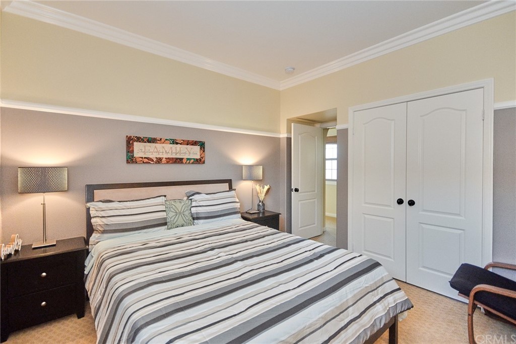 39 Conservancy Irvine, CA 92618 - Photo 25 of 32 a bedroom with a bed and a lamp