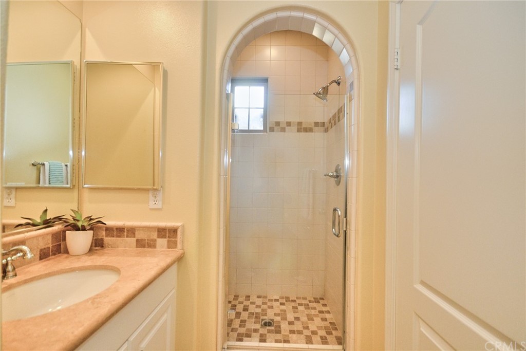 39 Conservancy Irvine, CA 92618 - Photo 27 of 32 a en suite bathroom with a granite countertop sink and a mirror