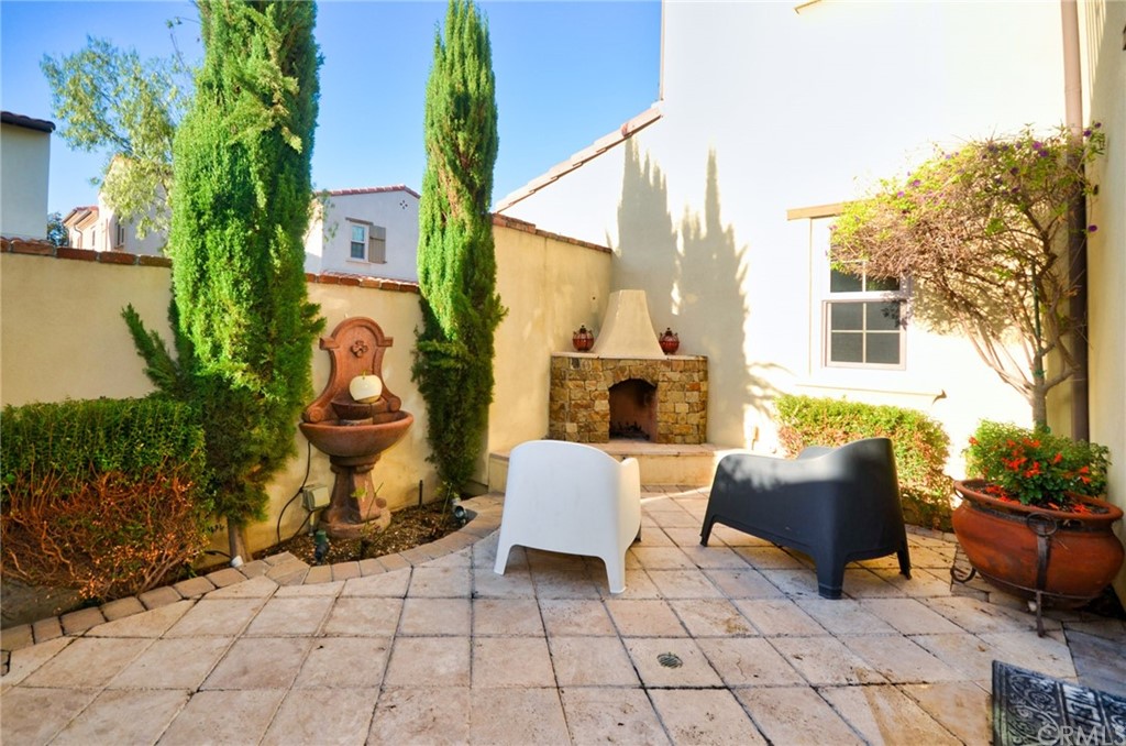 39 Conservancy Irvine, CA 92618 - Photo 32 of 32 a building outdoor space with patio furniture and potted plants