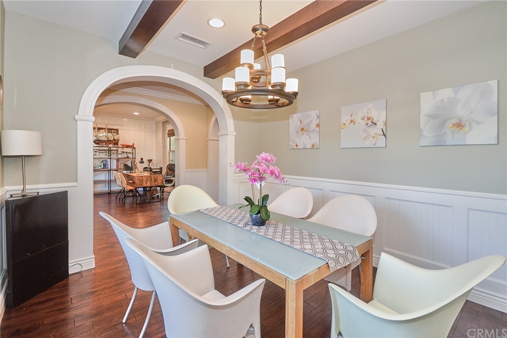 39 Conservancy Irvine, CA 92618 - Photo 6 of 32 a view of a dining room with furniture wooden floor and a chandelier