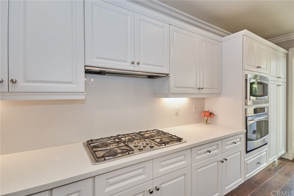39 Conservancy Irvine, CA 92618 - Photo 9 of 32 a kitchen with white cabinets and appliances