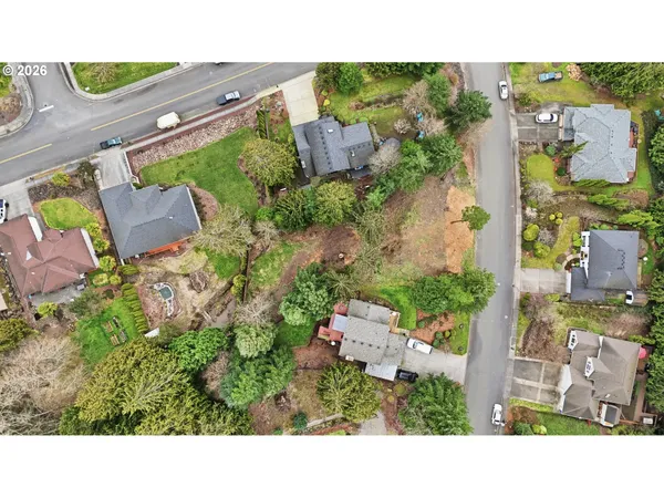 an aerial view of a house with a yard and lake view