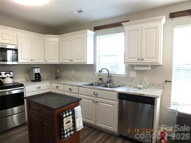 a kitchen with a sink stove and cabinets