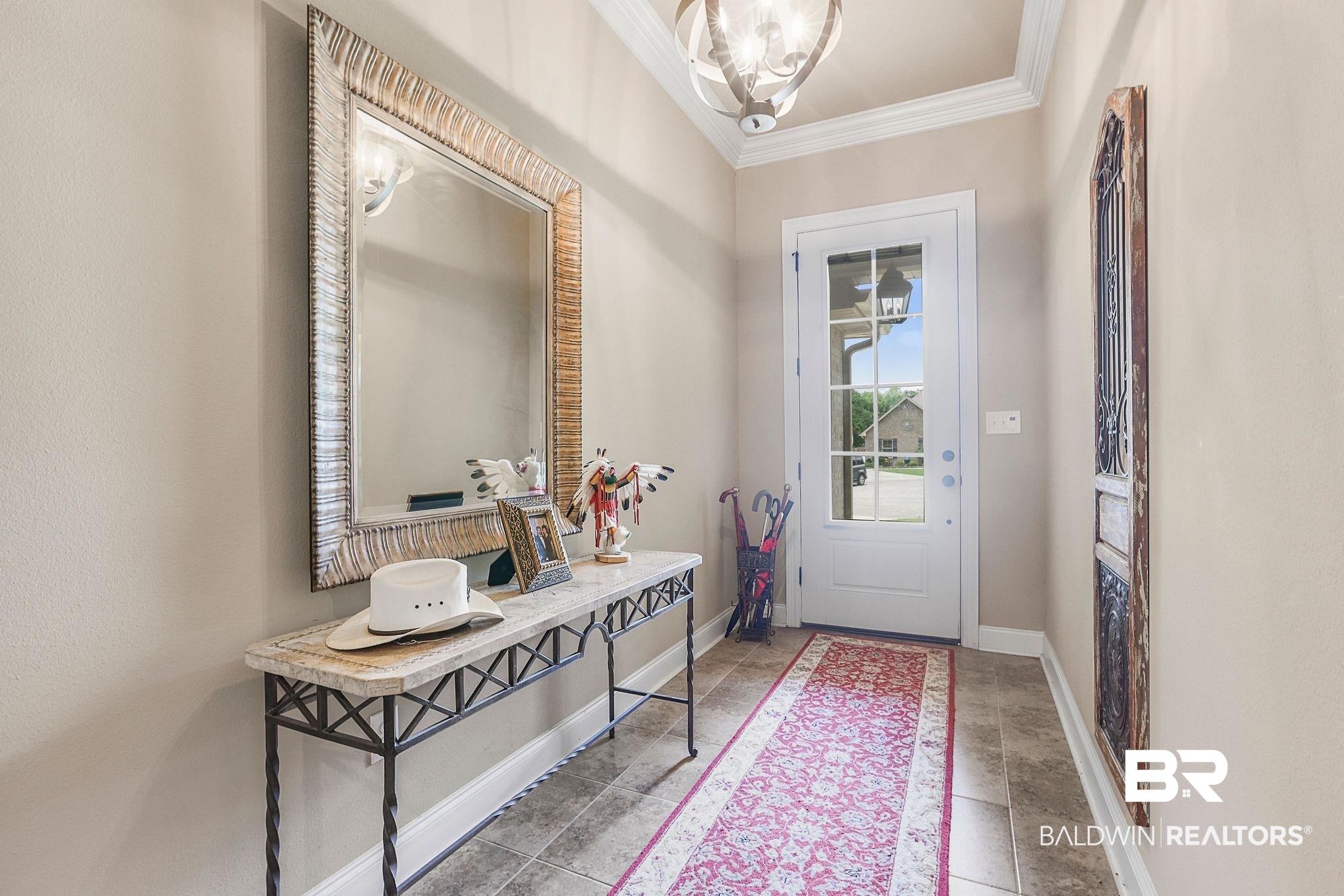 1090 Destin Avenue Foley, AL 36535 - Photo 4 of 30 Foyer with crown molding, baseboards, and a chandelier