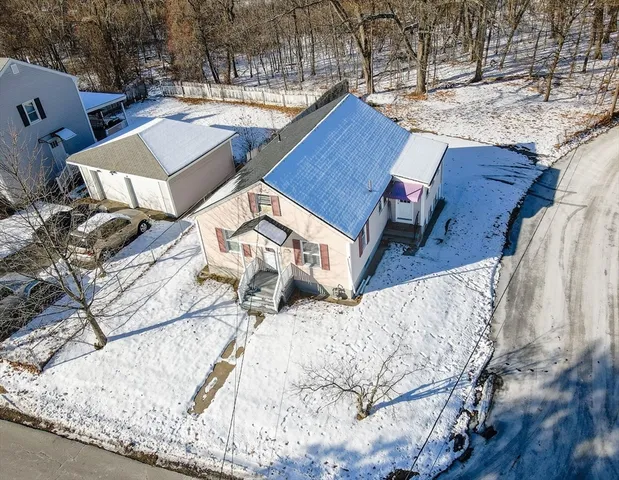 a roof deck with couch and wooden floor