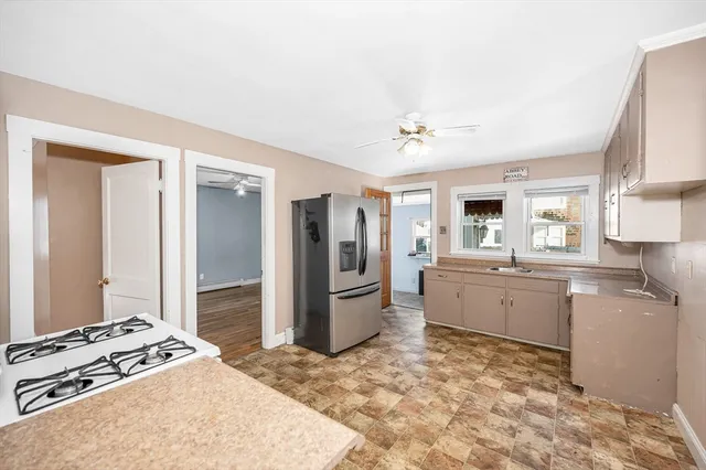 a large kitchen with a stove refrigerator and microwave