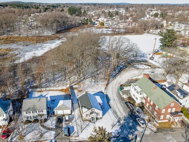 an aerial view of a house with a yard and lake view