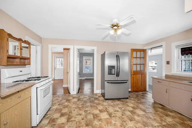 a kitchen with stainless steel appliances granite countertop a refrigerator and a stove