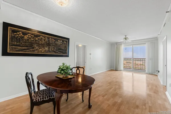 a view of a room with furniture and wooden floor