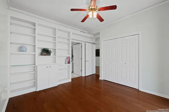 a view of empty room with wooden floor